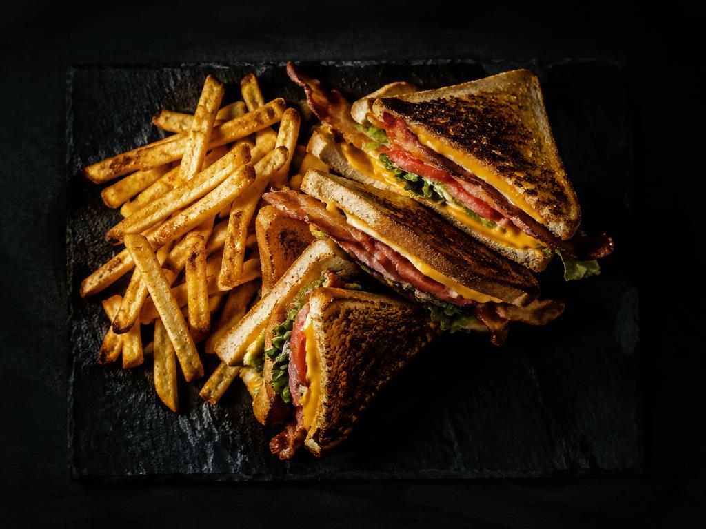 Grilled club sandwich with fries